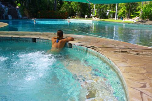 a woman is in a swimming pool at Aurora Kakadu Lodge in Jabiru