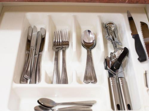 a drawer filled with silver utensils on a counter at Bella Vista Motel New Plymouth in New Plymouth