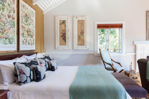a bedroom with a bed with pillows on it at Emily Moon River Lodge in Plettenberg Bay