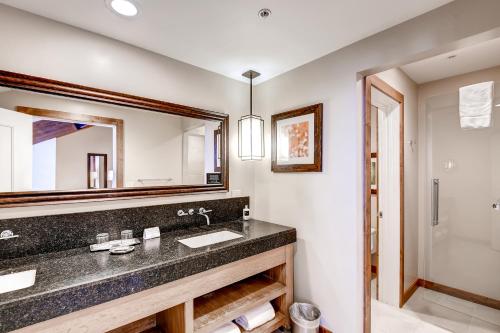 a bathroom with a sink and a mirror at The Osprey at Beaver Creek, a RockResort in Beaver Creek