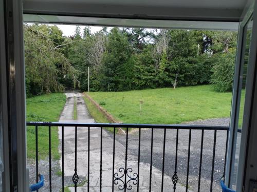 a view from a window of a field and a road at Couples Country Escape includes Private Indoor Pool and Hot tub in North Wales in Bagillt