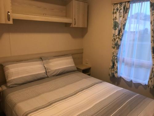 a bedroom with a bed and a window at Turlin Valley in Poole