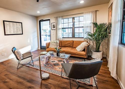 a living room with a couch and chairs at Stonewall Motor Lodge in Stonewall