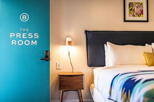 a bedroom with a bed and a door with the press room at Stonewall Motor Lodge in Stonewall