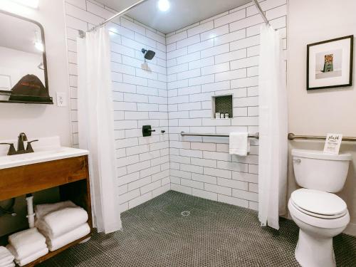 a bathroom with a toilet and a sink at Stonewall Motor Lodge in Stonewall