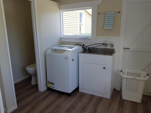 A kitchen or kitchenette at Kumara Historic Cottages