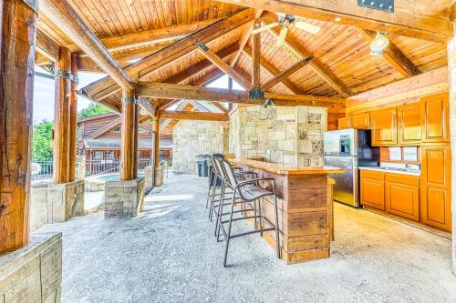 a kitchen with wooden ceilings and a bar with stools at Golf View Condo in Pigeon Forge