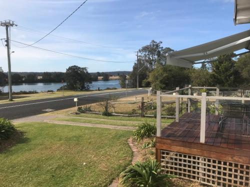 a building with a view of a river and a road at Moruya Holiday House in Moruya