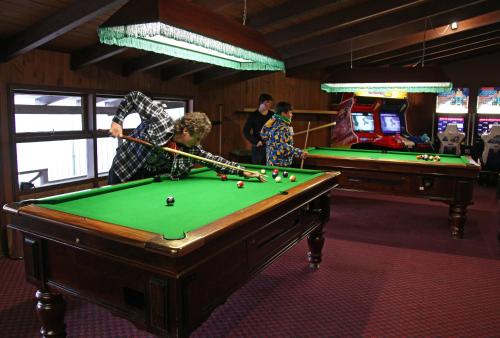 a group of people playing a game of pool at Ski Rider Hotel in Kalkite