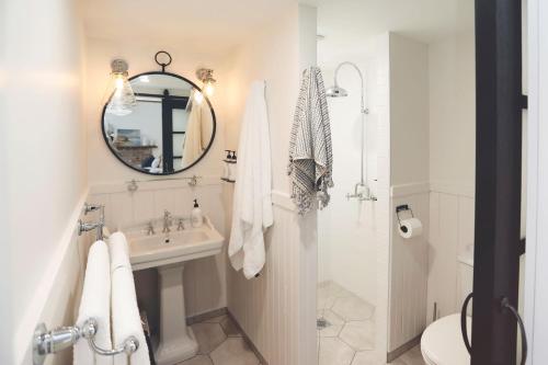 a white bathroom with a sink and a mirror at Ship Inn Stanley in Stanley