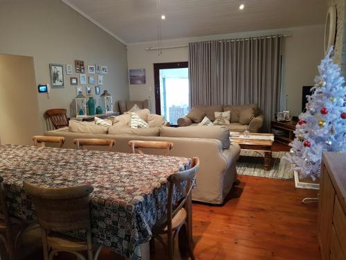 a living room with a christmas tree and a couch at Bushys Oak in Bushmans River Village
