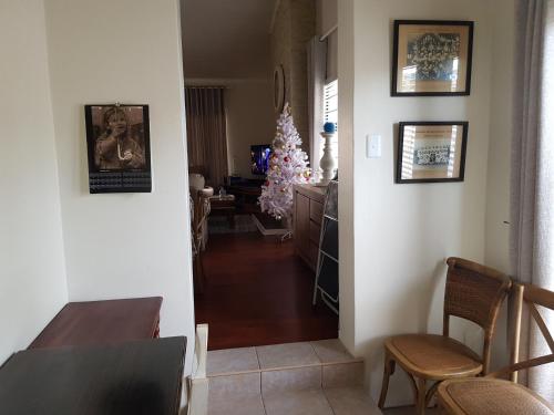 a dining room with a christmas tree and a dining table at Bushys Oak in Bushmans River Village