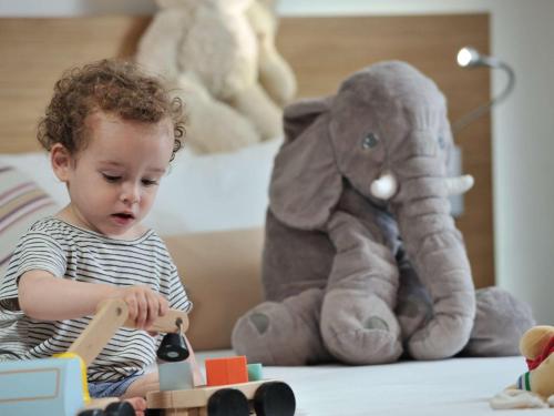 a little girl playing with blocks and an elephant toy at Novotel Marrakech Hivernage in Marrakech