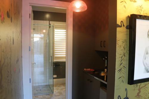 a bathroom with a shower and a glass door at Luxurious Escape,Matakana in Matakana