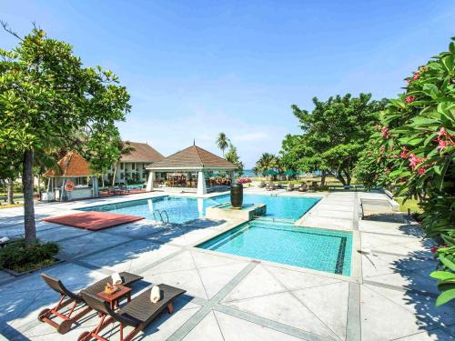 an image of a swimming pool at a resort at The Nouveau Chumphon Beach Resort And Golf in Chumphon