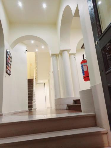 a room with a staircase and a fire extinguisher at Hotel Queen Mary in Brussels