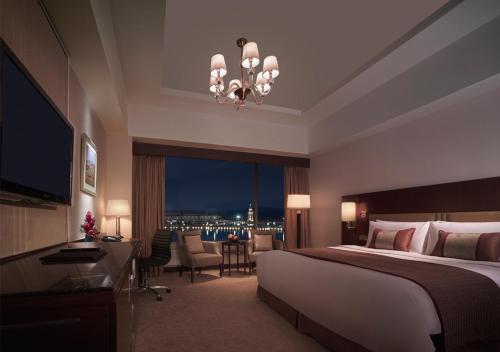 a hotel room with a bed and a large window at Shangri-La Manzhouli in Manzhouli