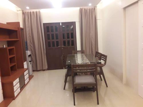 a dining room with a table and chairs and a door at Arcadio's Guest House in Mactan, Cebu in Cebu City