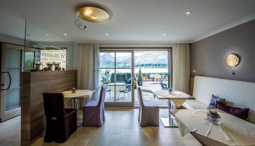 a restaurant with tables and chairs and a balcony at Hotel Garni Buchinger in St. Wolfgang