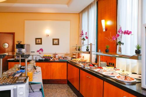 a kitchen with a long counter with plates of food at Mainake Costa del Sol in Torre del Mar