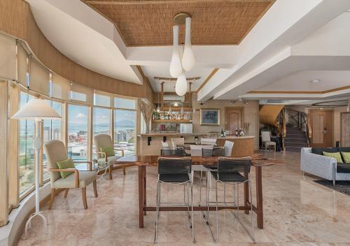 a kitchen and living room with a table and chairs at Vivere Hotel and Resorts in Manila