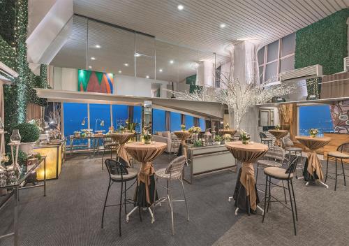 a restaurant with tables and chairs in a building at Vivere Hotel and Resorts in Manila