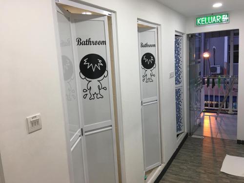 a hallway with a door with stickers on it at Signel Hostel in Kota Kinabalu
