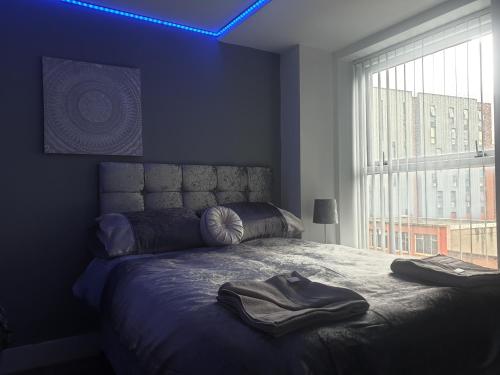 a bedroom with a bed with two towels on it at Shandon Apt premium Liverpool City Centre in Liverpool