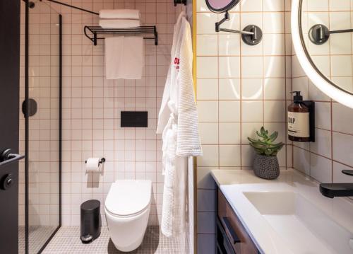 a bathroom with a toilet and a sink at Dave Levinsky, a member of Brown Hotels in Tel Aviv