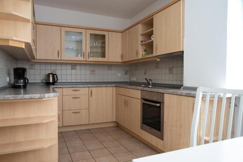 a kitchen with wooden cabinets and a sink at Alte Bahnhofstraße 12 in Karlstadt