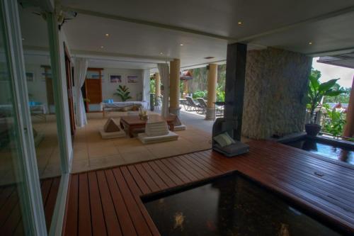 a living room with a pool in a house at Luxury 4 bedrooms Villa with Seaview Infinity Pool overlooking Surin Beach in Surin Beach