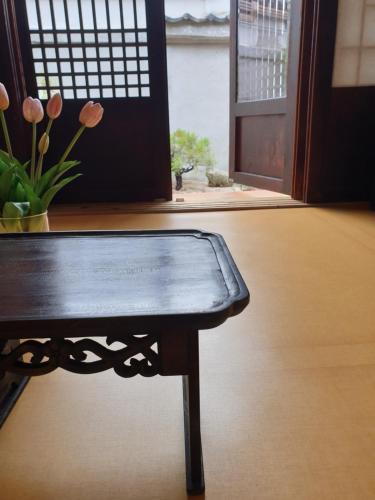 a wooden table sitting in a room with a window at GaEunChae in Jeonju