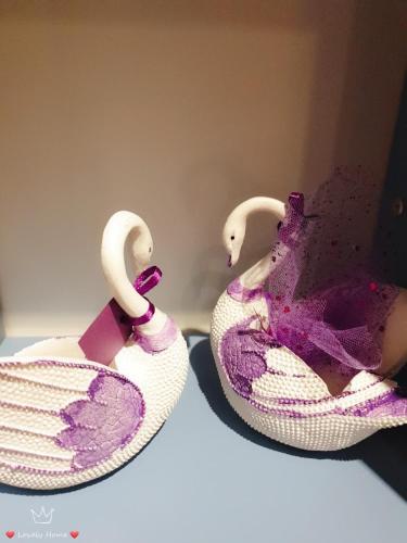 two stuffed swans are sitting on a table at LovelyHome@Geo Linked BRT/Sunway/Medical 中文房东 in Kampong Penaga