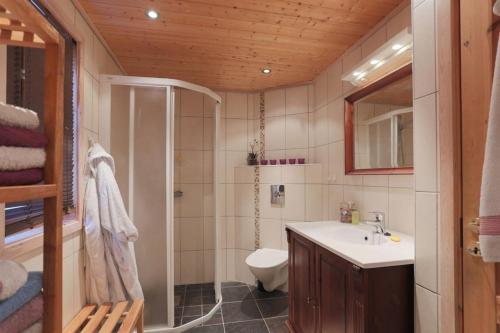 a bathroom with a sink and a toilet at Cabin in Hodlekve with 5 bedrooms & hot tub. in Sogndal