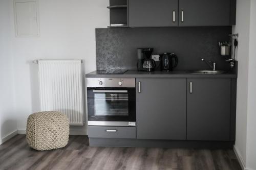 a kitchen with a stove and a chair in a room at TalBlick in Winterberg