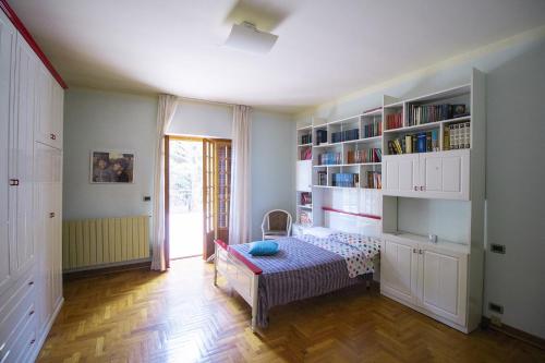 a room with a bed and a book shelf at Villa Pina in LʼAquila