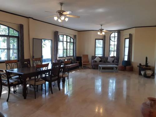 a large living room with a table and chairs at บ้านนกเคียงจัน ปากช่อง Nok Kiang Chan Home Pak Chong in Ban Nong Ka Cha