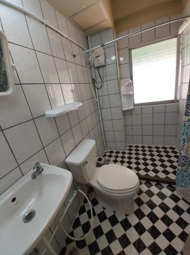 a bathroom with a white toilet and a sink at NB House in Karon Beach