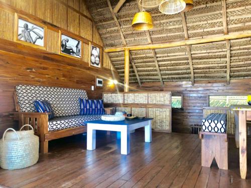 a living room with a couch and a table at Pura Vida Lodge in Morrumbene
