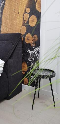 a black chair sitting next to a wall at WEST RESIDENCE APARTMENTS in Timişoara