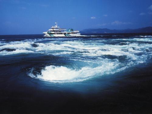 a cruise ship in the middle of a large body of water at Naruto Kaigetsu in Naruto