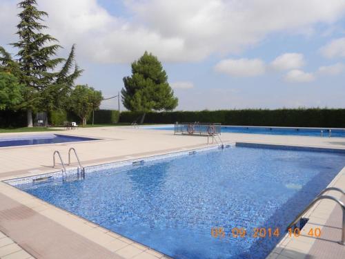 a large swimming pool with blue water at Cal Cabrer - El Vilosell in El Vilosell