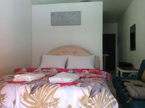 a bedroom with a bed with two pillows on it at NB House in Karon Beach