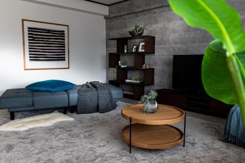 a living room with a couch and a television at Little Santa in Ginowan