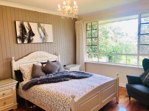 a bedroom with a bed and a chandelier at Stunning house with beautiful entertainment area!! in Marion