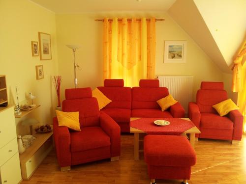 een woonkamer met rode stoelen en een tafel bij Meeresbrise Asternweg in Zinnowitz