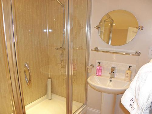 a bathroom with a shower and a sink at Riding Farm Cottages in Gateshead