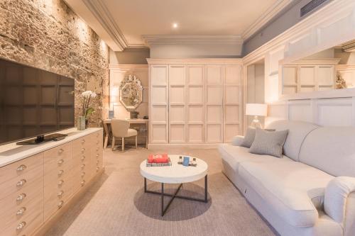 a bedroom with a bed and a couch and a table at The Scotsman Hotel in Edinburgh