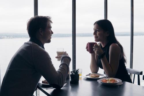 a man and a woman sitting at a table with drinks at DFDS Ferry - Copenhagen to Oslo in Copenhagen
