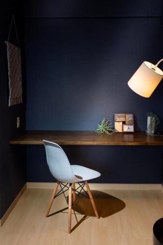 a white chair sitting in front of a desk at Little Santa in Ginowan
